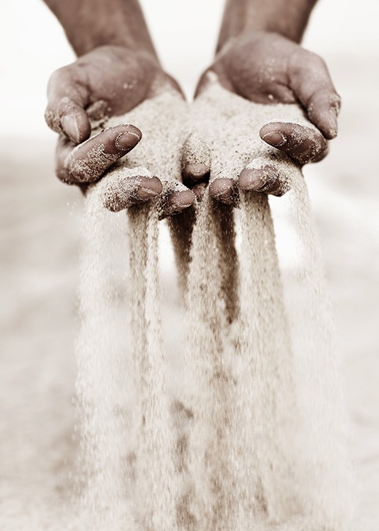  – Photograph of sand slipping through fingers