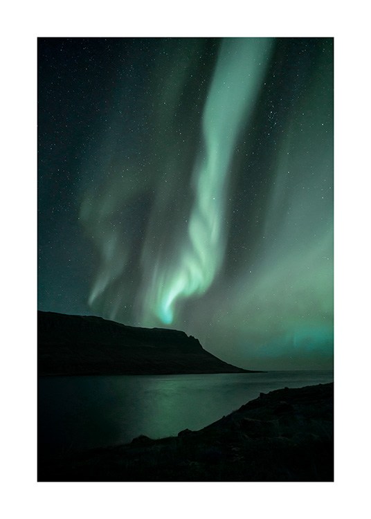  - Photograph of green northern lights behind mountains and ocean in Iceland