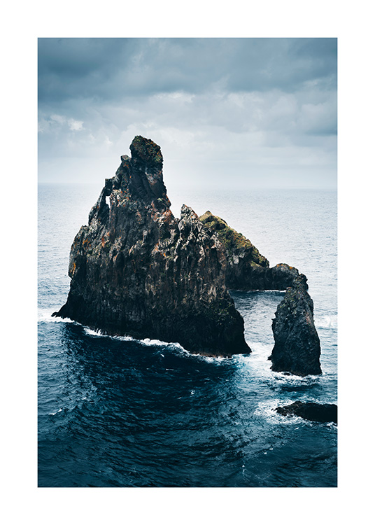  - Photograph of blue ocean with large rock formations in the middle