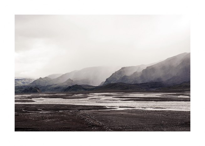  - Photograph of landscape with water puddles and mountains covered in fog