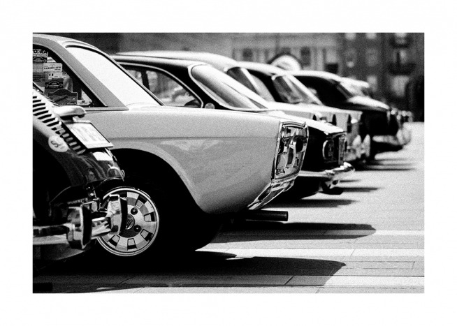  - Black and white photograph of a line of retro vintage cars in a parking lot