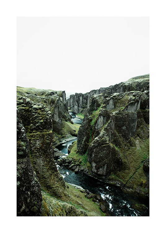  - Photograph of green mountain landscape with river flowing between cliffs