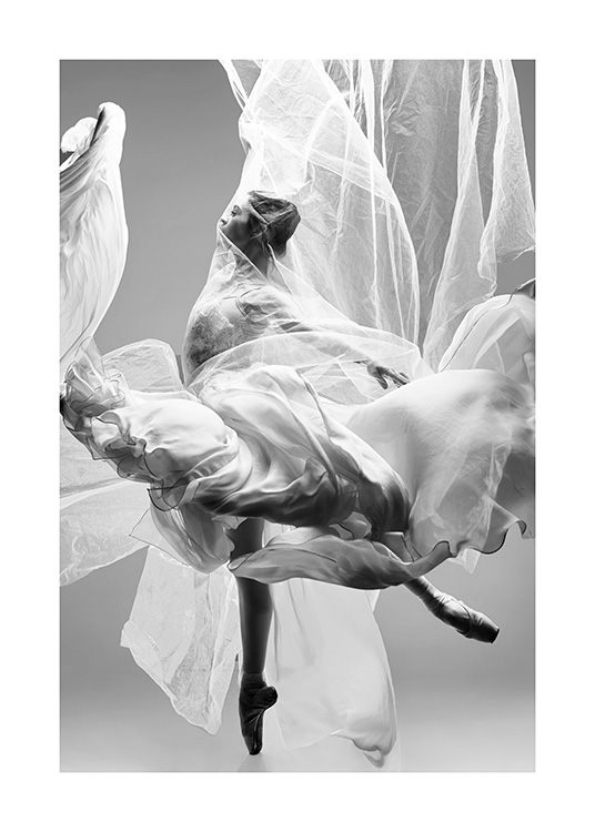  - Photograph of a ballerina in a white flowy fabric with pointed feet