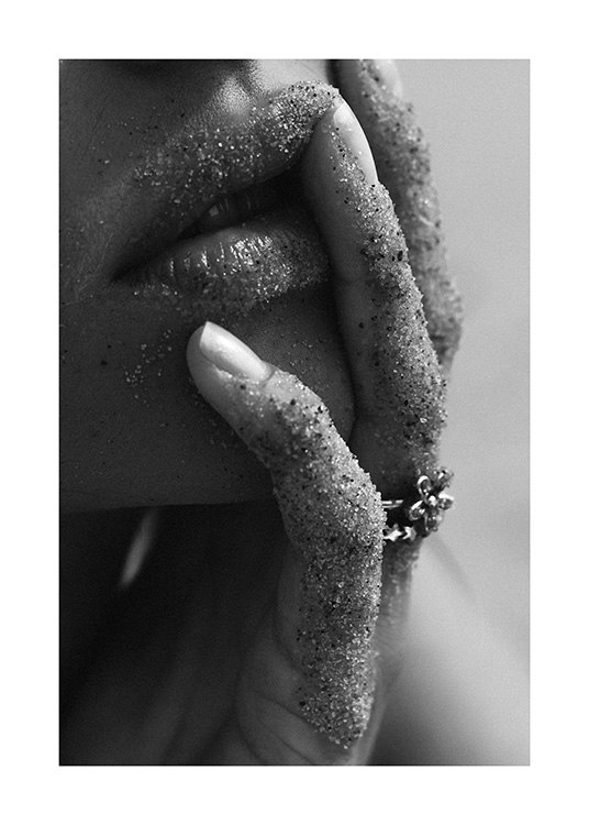  – Close up black and white photograph of a woman with sandy lips and sandy fingers