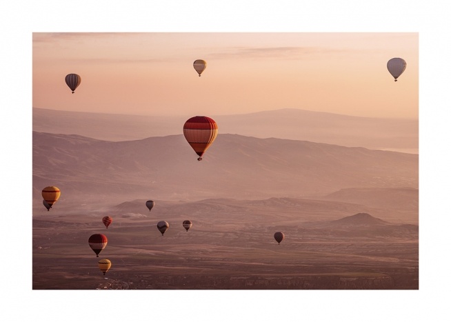  - Photograph of a landscape in the sunset with air balloons in the air