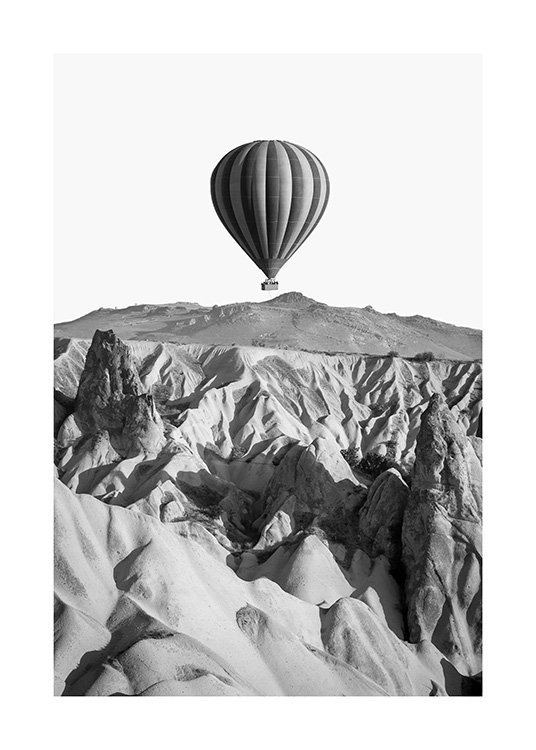  - Black and white photograph of a rocky mountain landscape and an air balloon