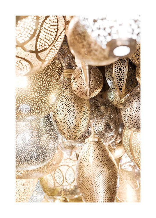  - Photograph of metal, golden lamps in a bunch with patterns on the lamps