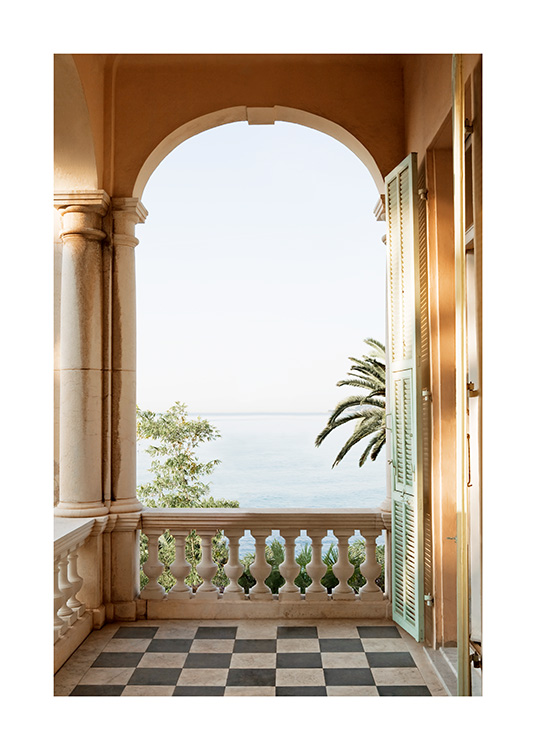  – Photograph of an arch on a balcony with palm trees and the ocean in the background