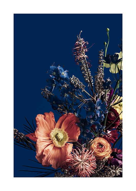  – Photograph of red and blue flowers in a colorful bouquet, against a dark blue background