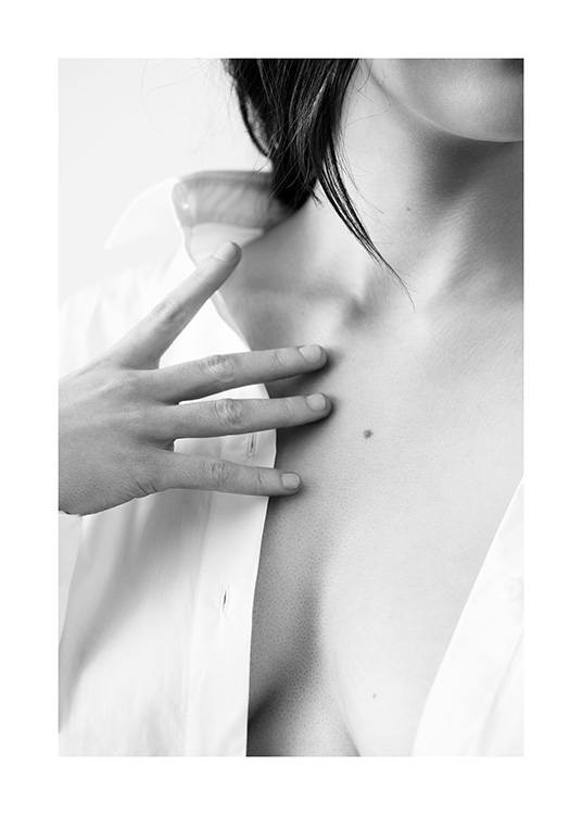  – Black and white photograph of a woman touching her chest with her fingertips