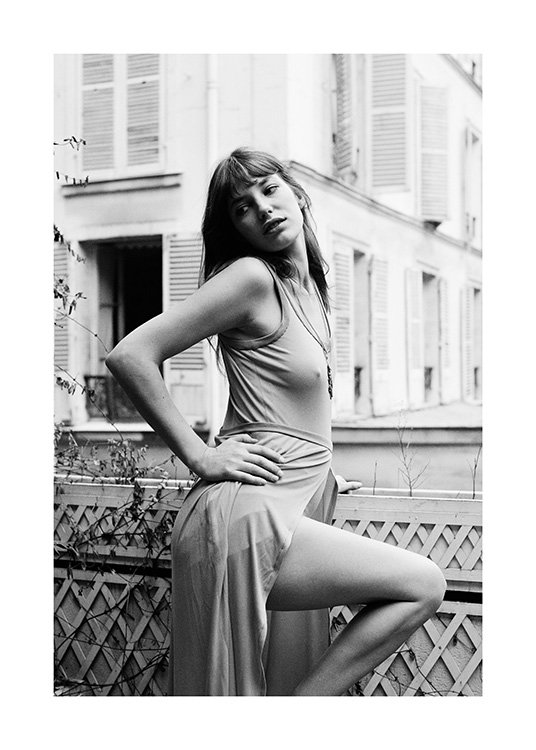  – Black and white photograph of Jane Birkin with her hand on her hip, standing on a balcony
