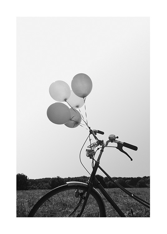  – Black and white photograph of a bike with balloons tied to it