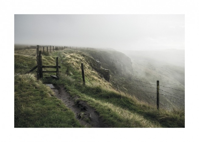 – Photograph of a green landscape covered in fog, with a path next to a fence at the hilltop