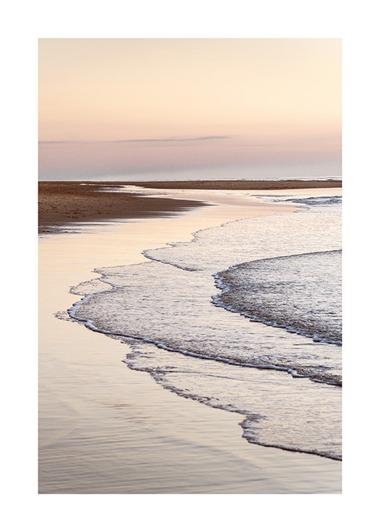  – Photograph of still waves coming onto a beach with a light pink sky in the background