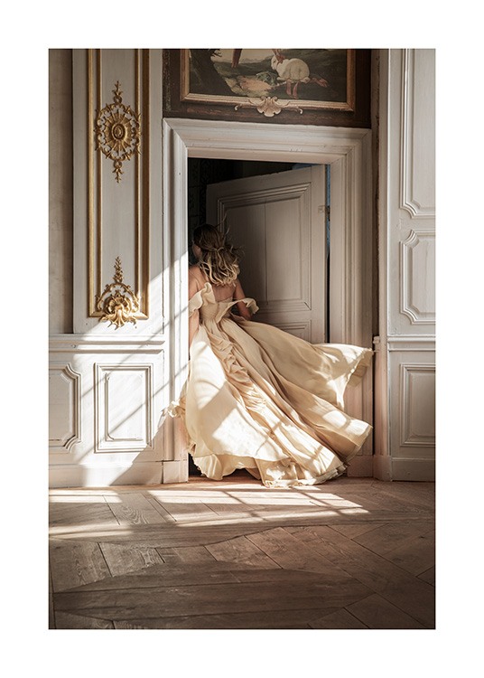  – Photograph of a woman in a beige dress walking through a door with baroque details