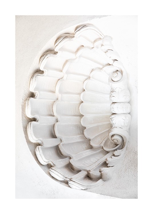  – Photograph of a seashell shape carved out in white concrete