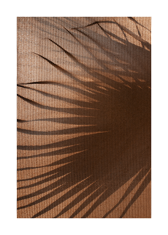  – Photograph of a large leaf shadow on a brown, structured fabric