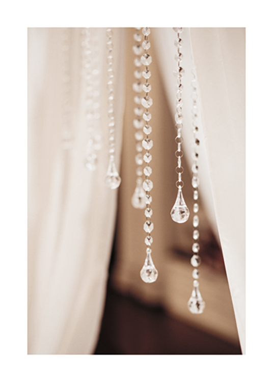  – Photograph with close up of a bunch of crystal pendants with white curtains behind them