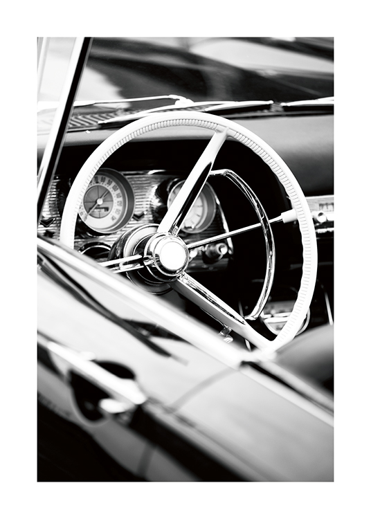  – Black and white photograph of a vintage cabriolet's steering wheel and dashboard