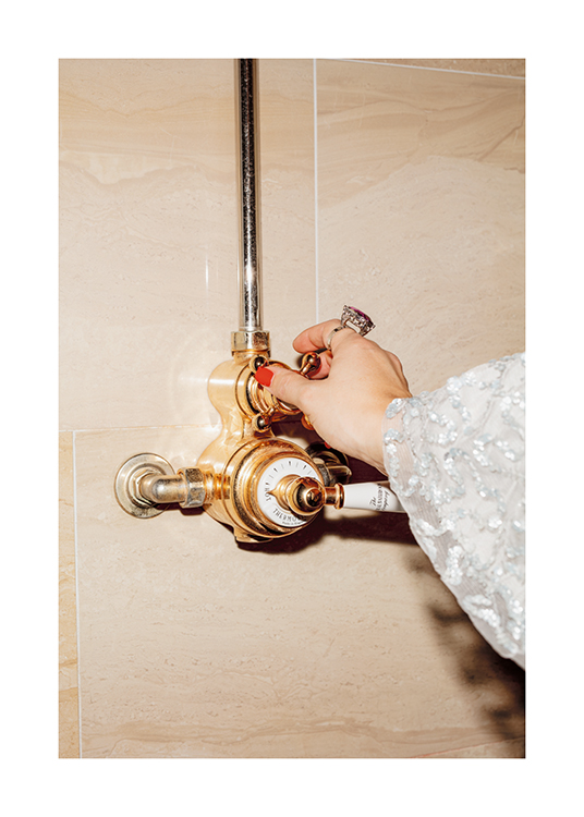  – A woman switching on an old-fashioned gold bathroom shower