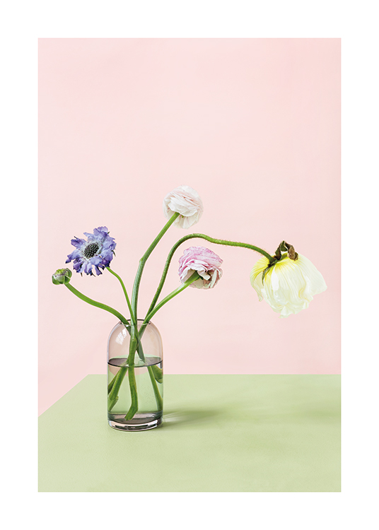  – Photograph of colourful flowers in a vase standing on a green table,