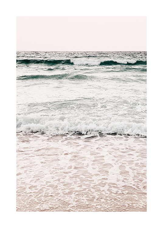  – Photograph of an ocean with small, calm waves and sea foam coming onto the beach