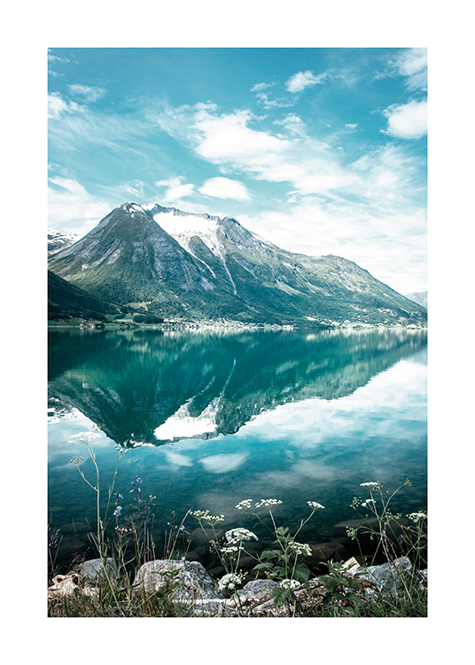  – Photograph of a mountain reflected in a still lake with flowers in the foreground