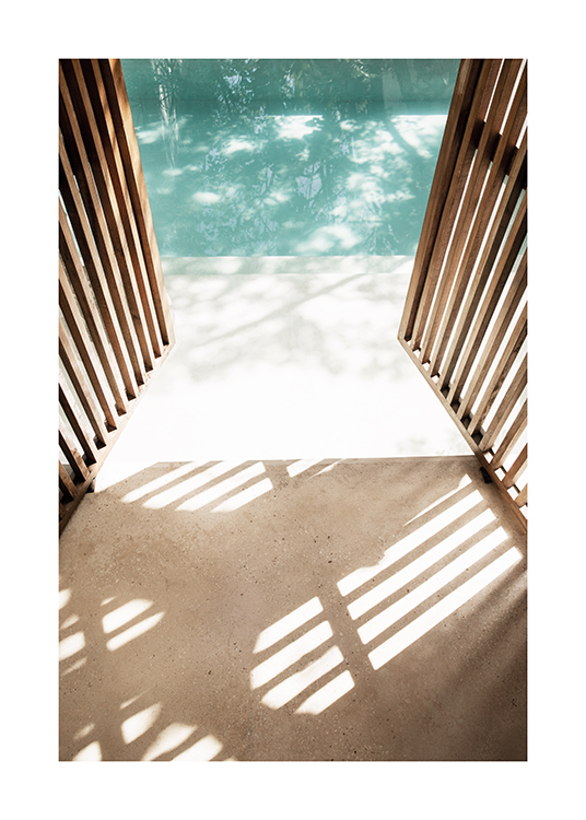  – Photograph of a wooden, open door with a pool in the background