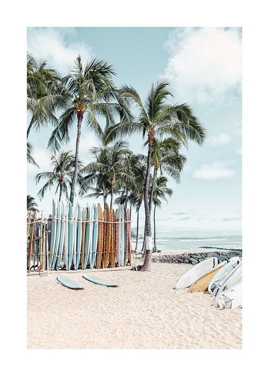  – Photograph of surfboards on the beach with palm trees and the ocean in the background