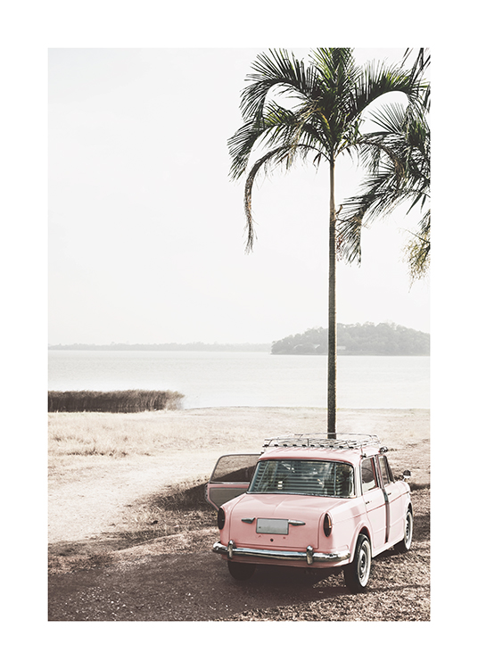  – Photograph of a retro car in pink standing next to a palm tree on a beach