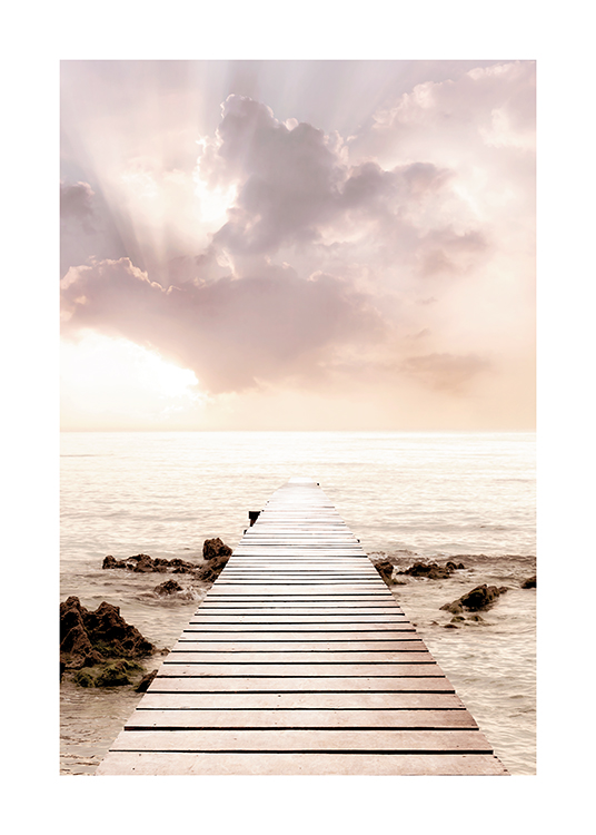  – Photograph of a pastel lilac and pink sky behind the sea with a jetty in the foreground