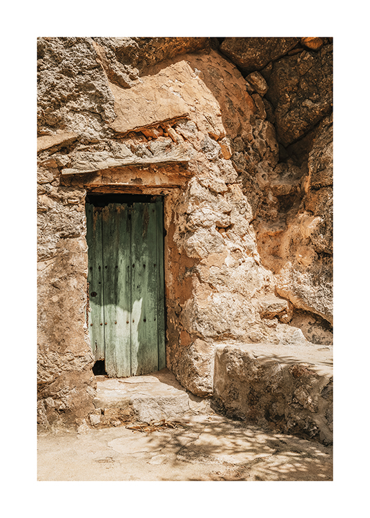  – A rustic green door in a cave-like building
