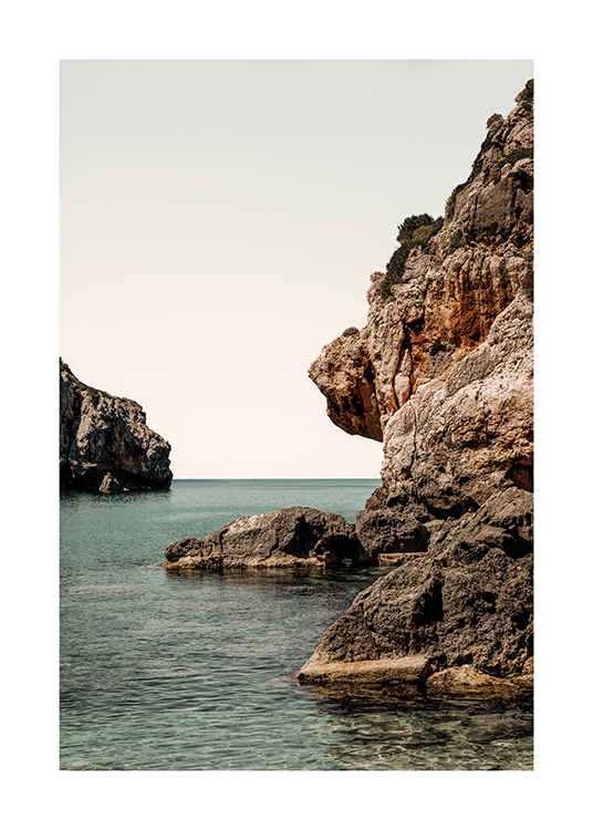  – A photograph of rocks that give way to the sea