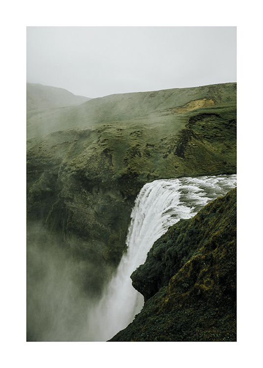  – Photograph of a green landscape with a waterfall in the centre and fog covering the landscape