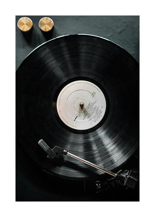  – Photograph of an old vinyl player with a black vinyl record on it