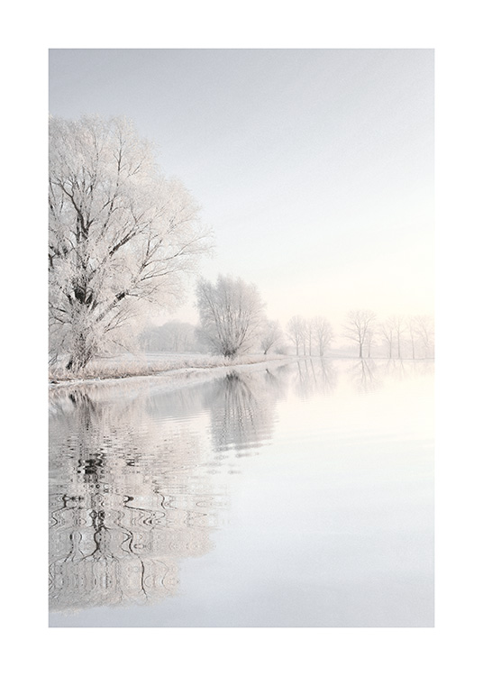  – Photograph of a lake next to trees and a landscape covered in snow, reflecting in the lake