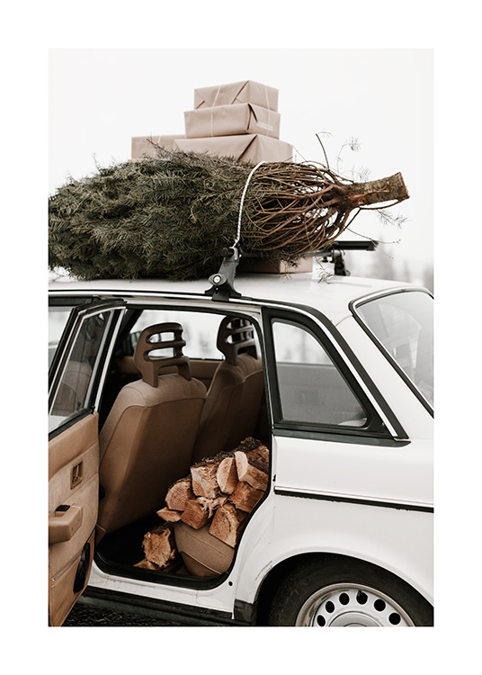 – Photograph of a white, vintage car with presents and a Christmas tree on the roof and wood logs inside