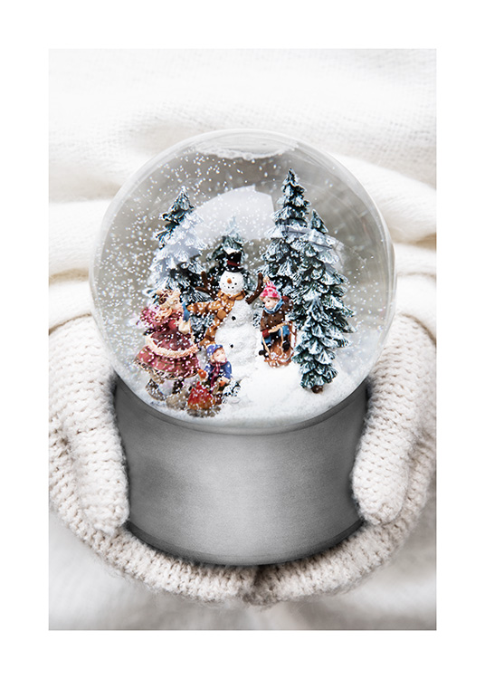  – Photograph of a little snow globe with a snowman, trees and kids inside it