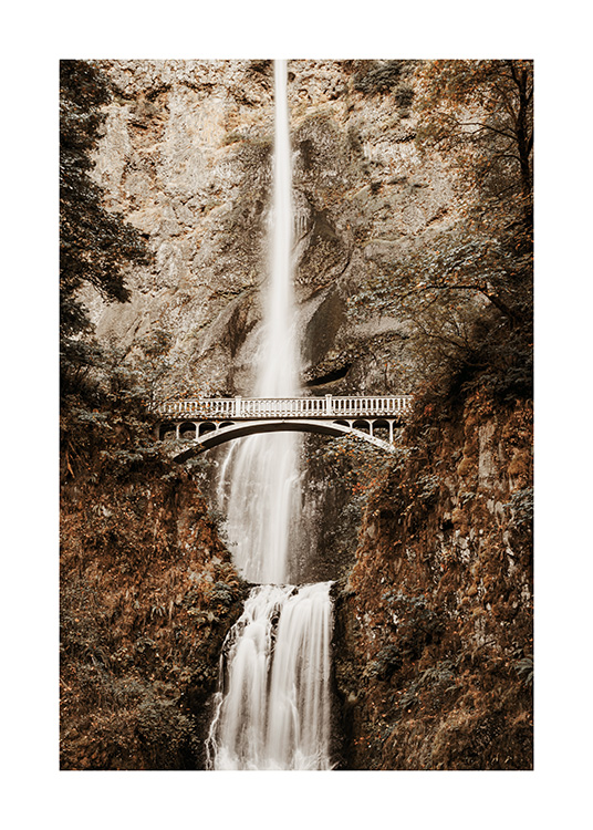  – Photograph of a waterfall in the mountains with a bridge in the middle