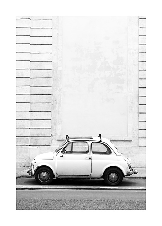  – Black and white photograph of a little retro car parked in front of a building with a striped effect