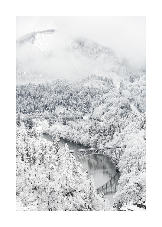 – A photograph of a winter landscape from above, with a lot of snow and fir trees around the mountains