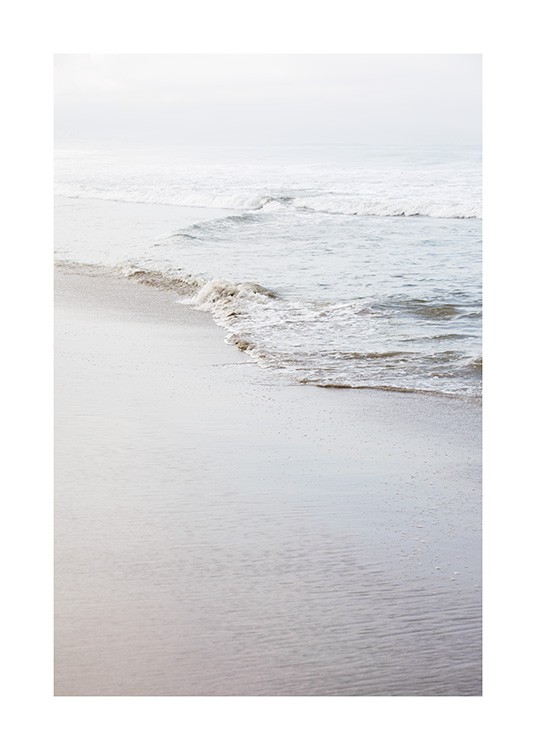  - Photograph of a beach and calm shoreline with a small wave